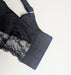 Black Elomi Charley longline lace bra on a mannequin against a white background. Style EL4381. Hooks view.