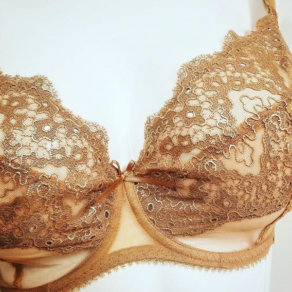 Maison Lejaby brings you a gold, balconette bra with intricate embroidery, sheer mesh, and 3 part cups. Style G21533.